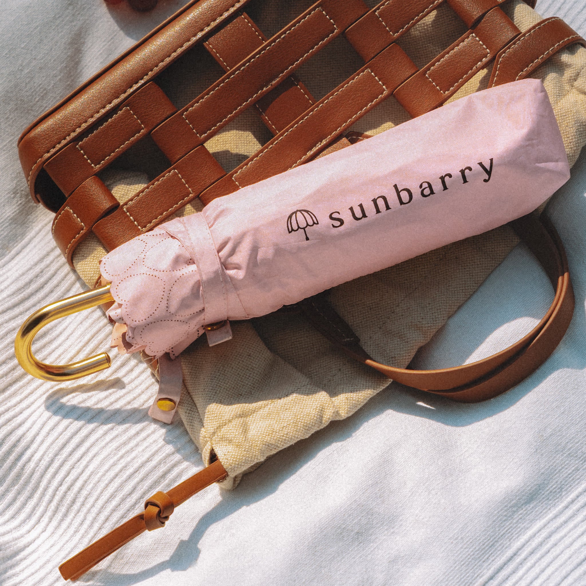 Sunbarry Romantic Breezer in Blush Rosé folded on a picnic blanket – heart trim and golden J-handle#Color_Blush Rosé